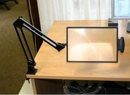 Table-top magnifier mounted on the tabletop